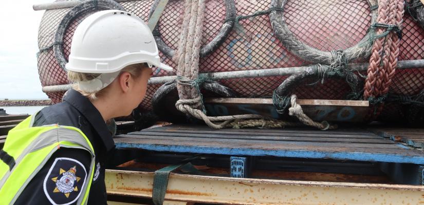 Image of an AFMA Fisheries Officer inspecting a fish aggregating device retrieved from northern Australian waters 