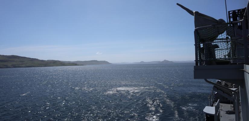 Image taken from the side of the French frigate looking over the ocean to islands in the distance