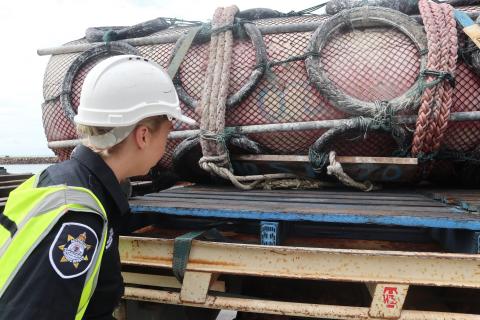 Image of an AFMA Fisheries Officer inspecting a fish aggregating device retrieved from northern Australian waters 