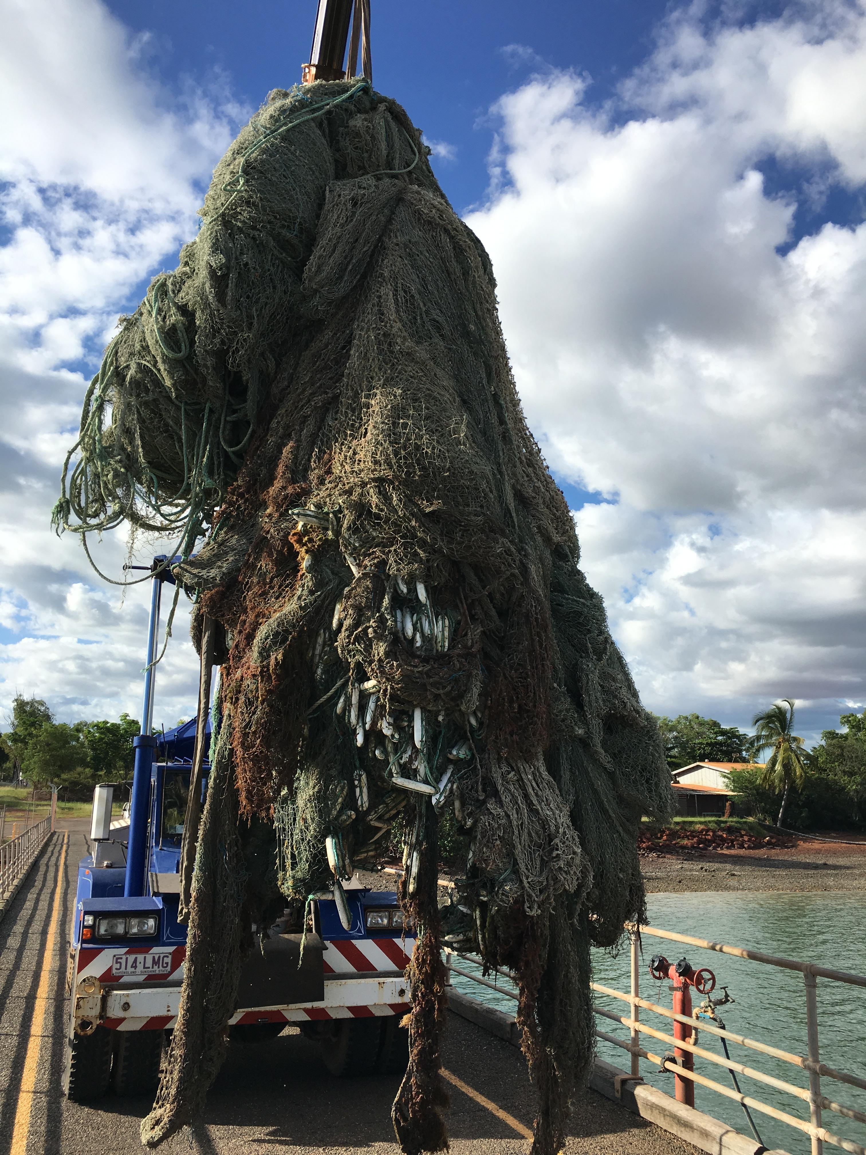 Image of ghost net being lifted onto land